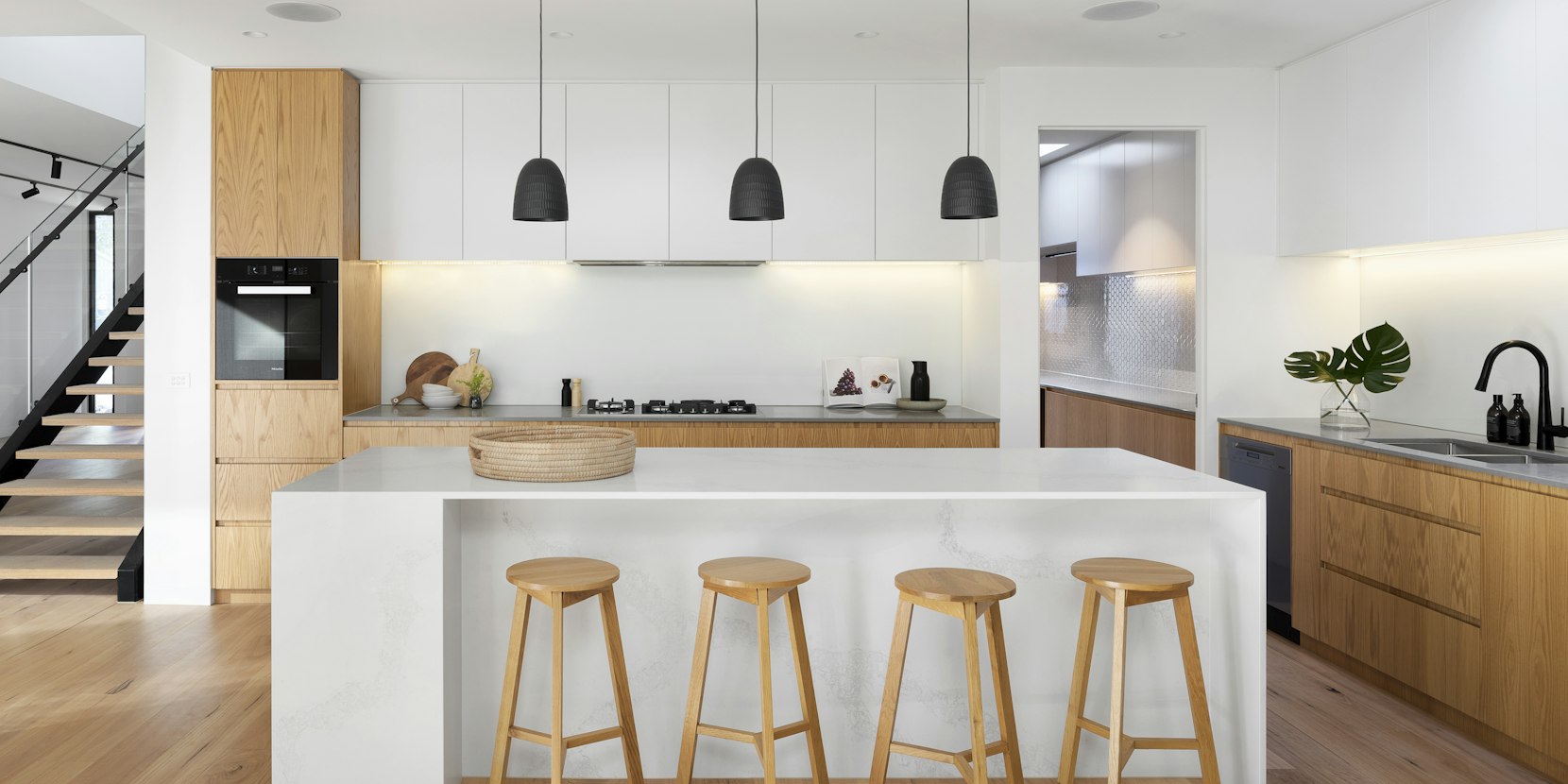 Chandelier hanging above a living and dining space